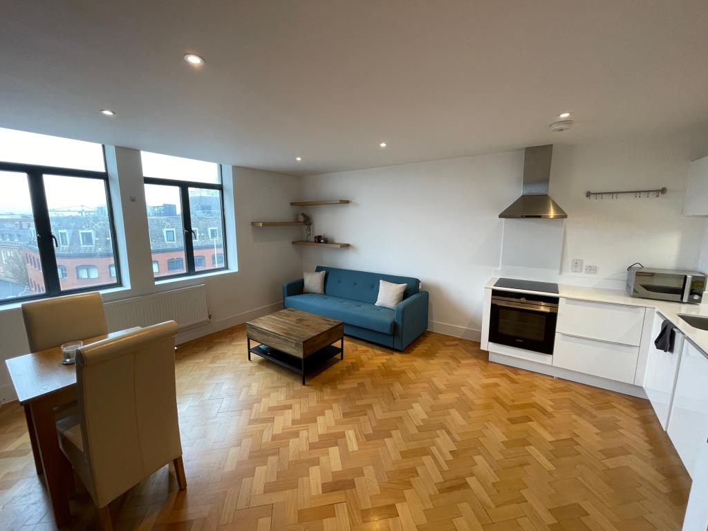 Lot: 102 - ONE-BEDROOM 4TH FLOOR CITY CENTRE APARTMENT - Living Room and kitchen area in city centre apartment